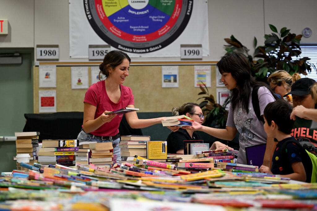 Distributing books, backpacks and other supplies at Backpack Attack event